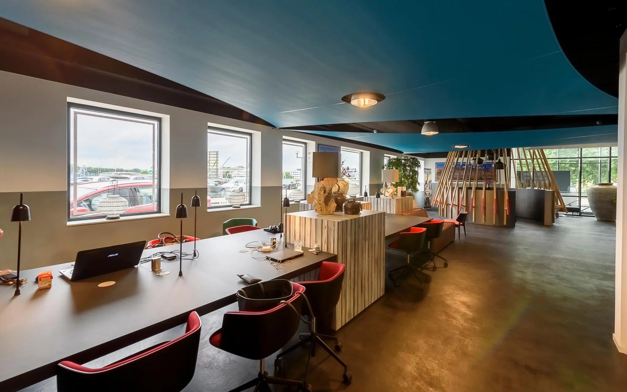 Moderne, open kantoorruimte in Rivium Quadrant met werkplekken, designmeubilair en grote ramen met uitzicht naar buiten.